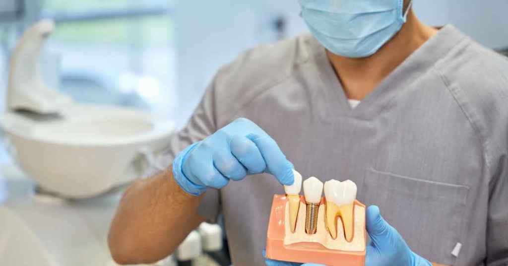 Dentist demonstrating dental implant placement using a tooth mode